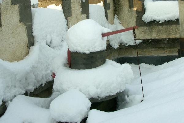 Clock bell wreathed in snow